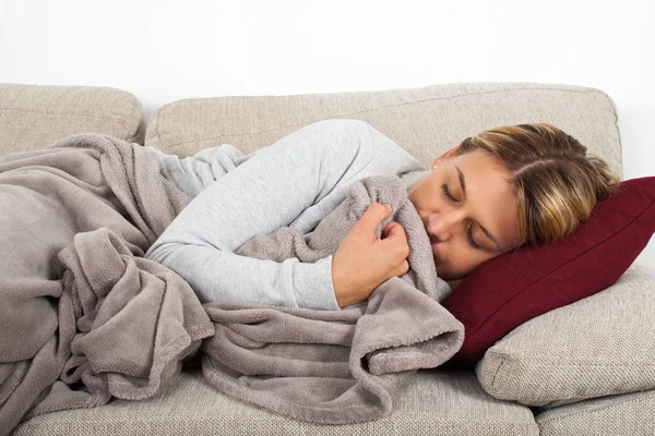 Sick Young Woman Lying Couch Wrapped Grey Blanket — Stock Photo, Image