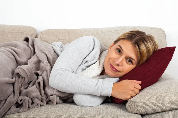 Sick Young Woman Lying Couch Wrapped Grey Blanket — Stock Photo, Image