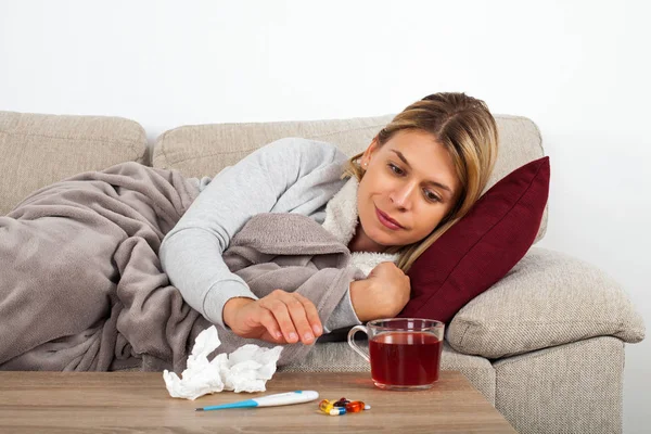 Sick Woman Lying Couch Wrapped Warm Blanket Medication Thermometer Tea — Stock Photo, Image