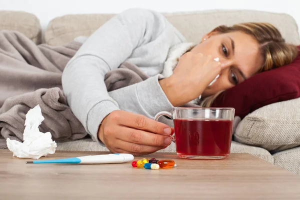 Sick Woman Lying Couch Wrapped Warm Blanket Medication Thermometer Tea — Stock Photo, Image