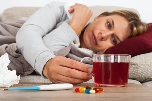 Sick Woman Lying Couch Wrapped Warm Blanket Medication Thermometer Tea — Stock Photo, Image