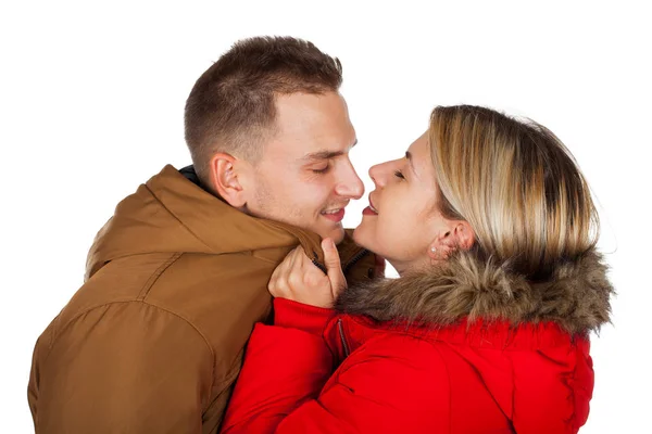 Couple Wearing Winter Clothing Red Brown Hooded Parka Jackets Kissing — Stock Photo, Image