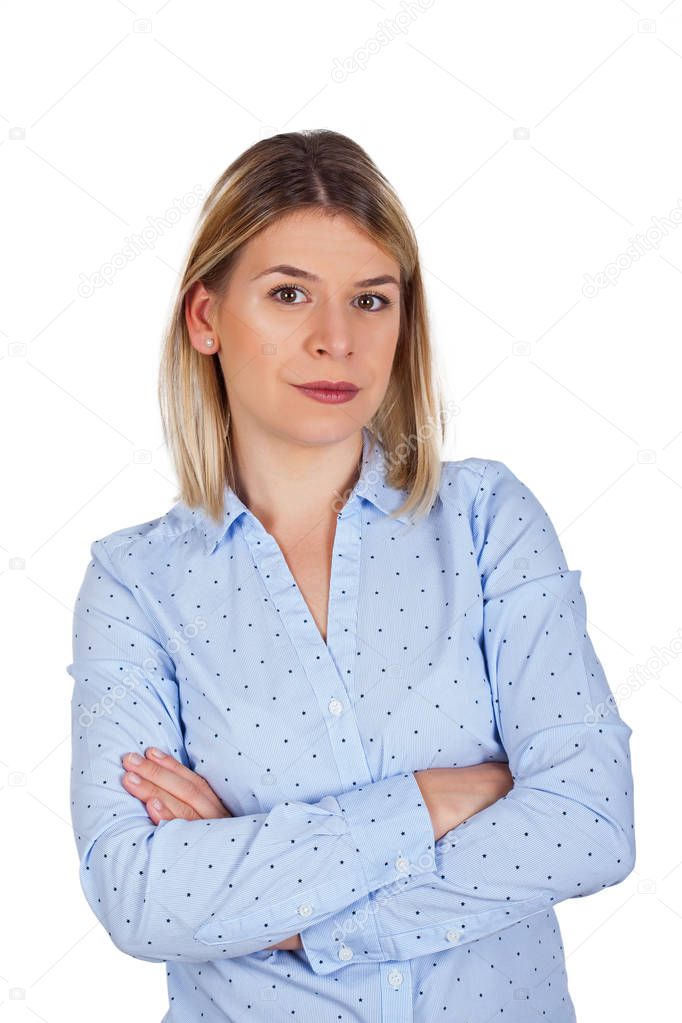 Confident young businesswoman with arms crossed is looking to the camera on isolated
