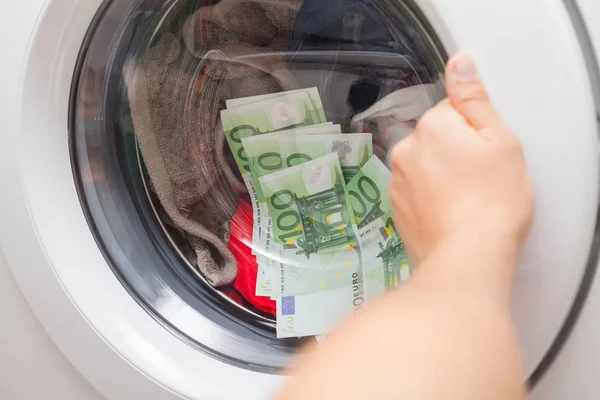 Lot of money stuck in the washing machine, man trying to open the door
