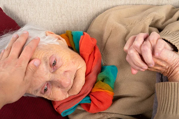 Close Picture Sick Elderly Woman Fever Resting Sofa Caregivers Hands — Stock Photo, Image