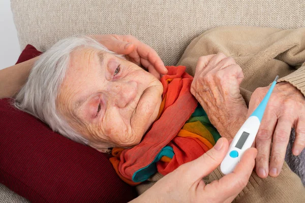 Close Picture Sick Elderly Woman Resting Sofa Caregivers Hand Holding — Stock Photo, Image