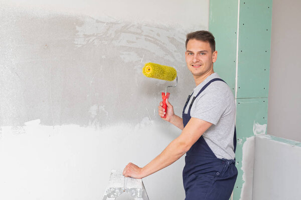 Worker painting the walls