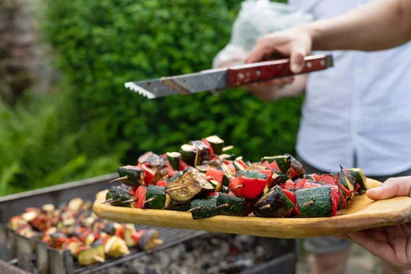 Grilling vegetables on skewers outdoor