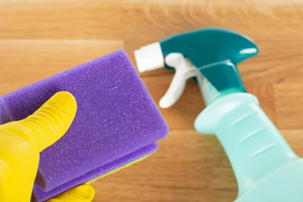 Picture of colorful cleaning supplies and tools on wooden background