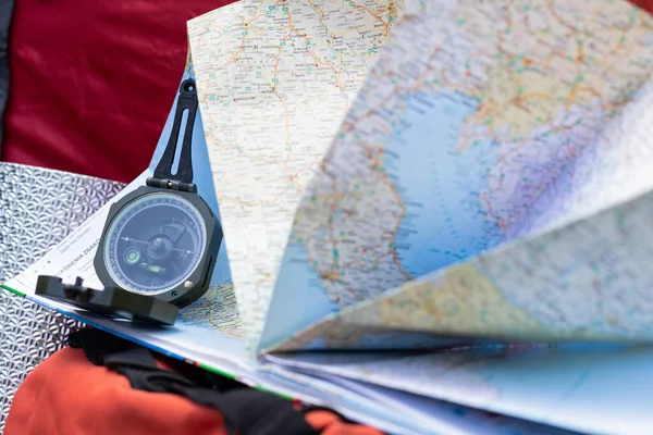 Close up picture of compass and map - preparing for camping trip in the woods