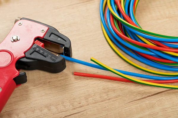 Tools for electrician needs: wire strippers, pliers, cables