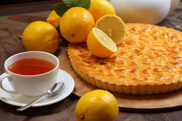 close-up of traditional lemon pie with tea on a tray