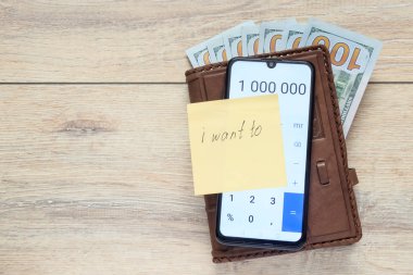 bize dolar ile Organizatör ve açık hesap makinesi numaraları 1 000 000 ve yapışkan notu ile levha bir yazıt ile ben istiyorum için arka planda bir masa kopya alanı ile