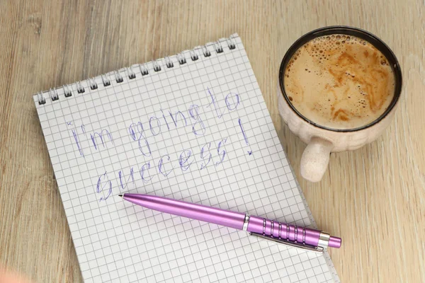 mug with coffee and a pen on a notebook with the inscription I\'m going to success