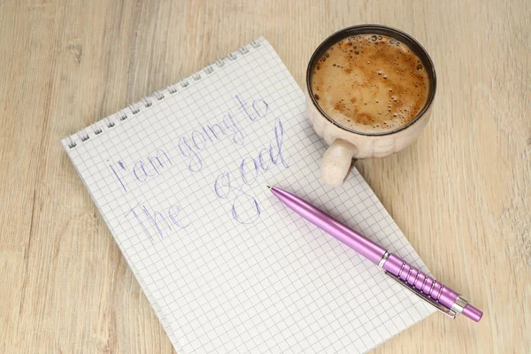 mug with coffee and a pen on a notebook with the inscription I\'m going to the goal