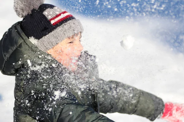 Child plays with snow