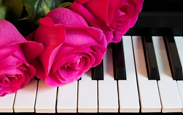 Buquê de rosas cor de rosa no piano. Flores em um instrumento musical. Cartão de felicitações. Dia internacional da mulher, dia da mãe, romance, amor, flores — Fotografia de Stock