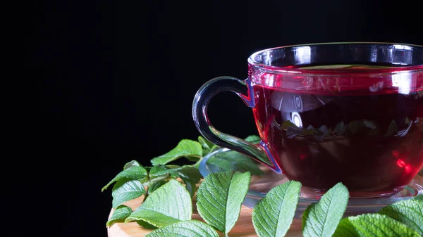 Tea time: cup of tea. Creative layout made of cup of hibiscus tea and tea leafs. Red tea, carcade, karkade, rooibos. Oriental, cozy, ceremony, tradition, japanese, leafy, hygge, autumn, 5 o\'clock