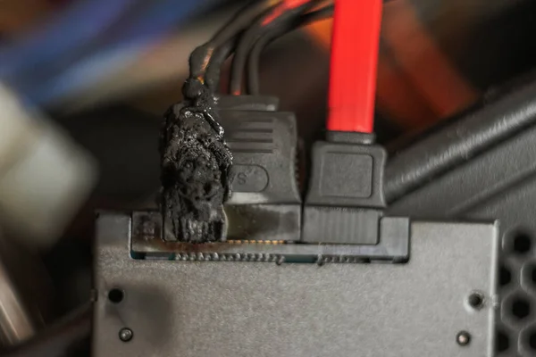 Burned ssd, charred computer wiring, short circuit, fused power cable — ストック写真
