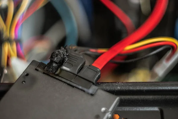 A charred, suffered a power surge burnt hard drive. suffered a power surge. black with soot. short circuit