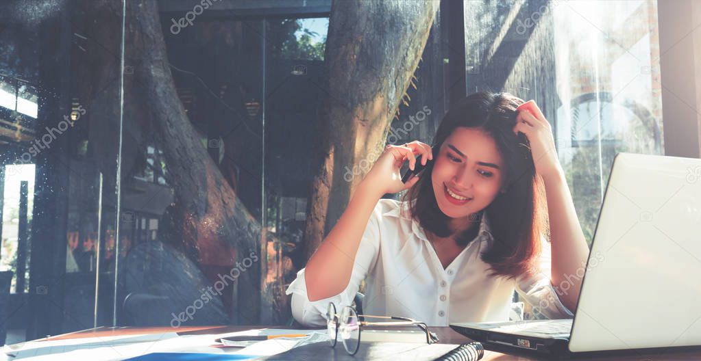 Asian businesswomen talking smartphone in coffee cafe, vintage colors