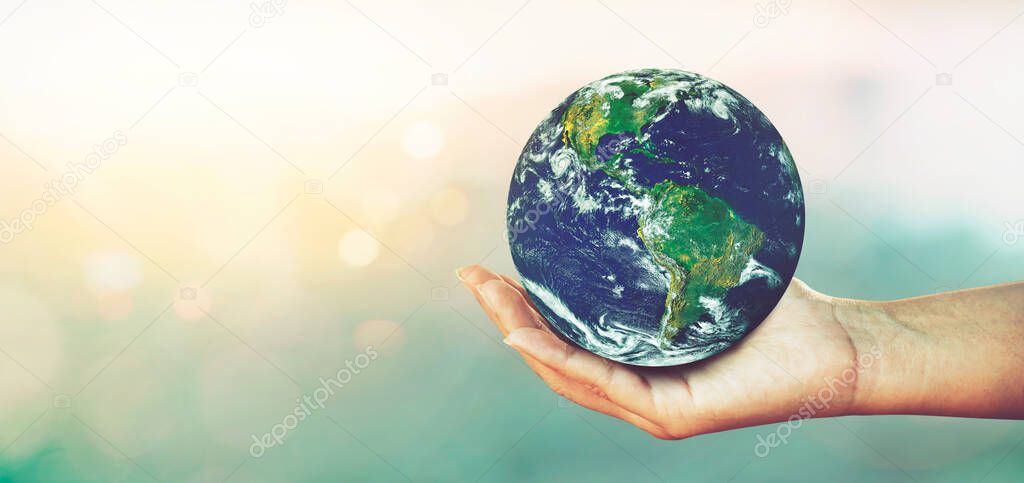 Woman hands holding global over blurred nature backgrounds, Concept of Love the World.Elements of this image furnished by NASA.
