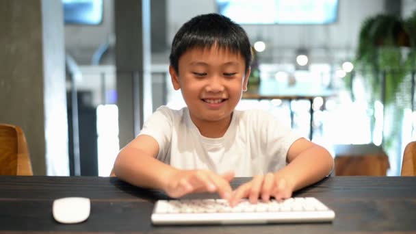 Asian Boy Learns Computer Presses Keys Moves Mouse — Stock Video