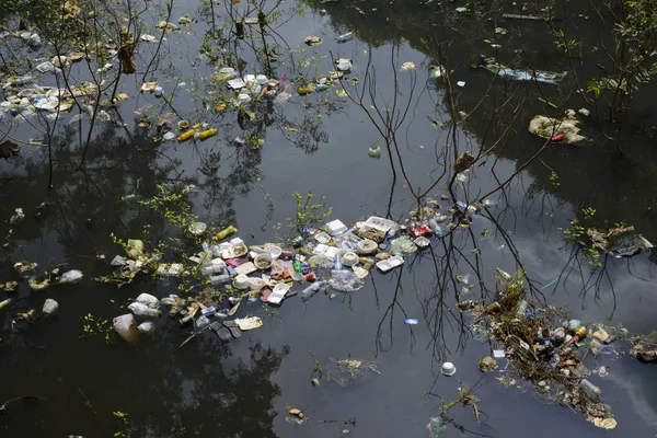 Water pollution effects dirty garbage in canal