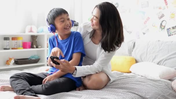 Mother Son Wearing Headphones Using Smartphone Singing Song Together Home — Stock Video