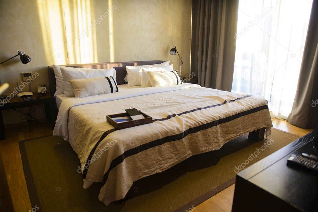 Comfortable luxury hotel room with pillows and bed in the morning
