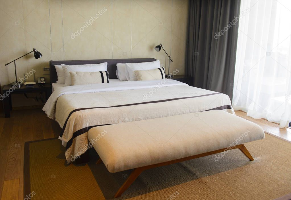 Comfortable luxury hotel room with pillows and bed