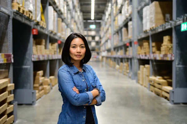 Portrait of woman manager with arms crossed in warehouse