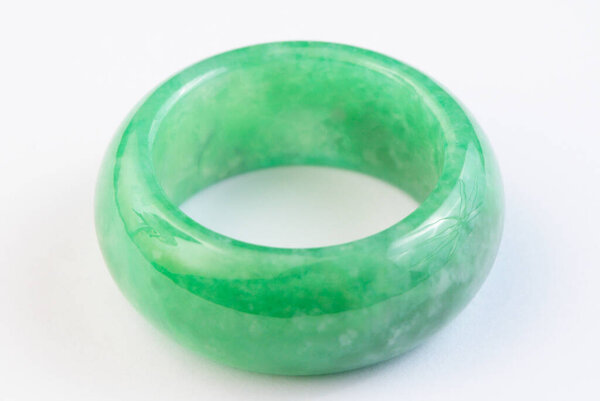Green jade ring on white background