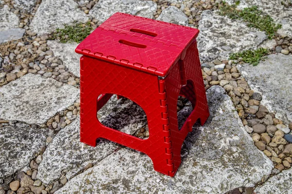 Red stool on a foot-way.