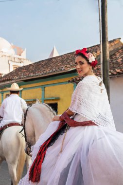 Original jarocha riding in colorful city of veracruz clipart