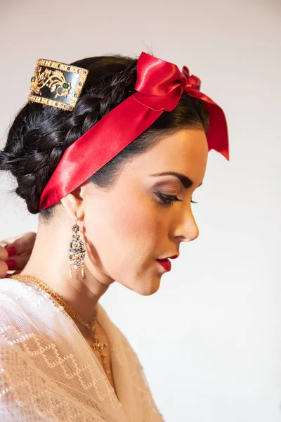 preparing Jarocha with her gold jewelry, her white dress and tortoiseshell comb,