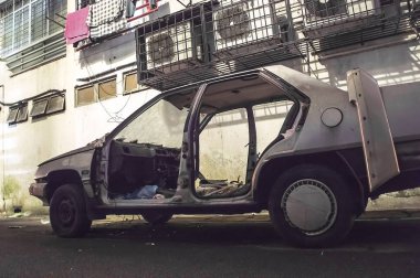 Wrecked and burnt car in an alley 