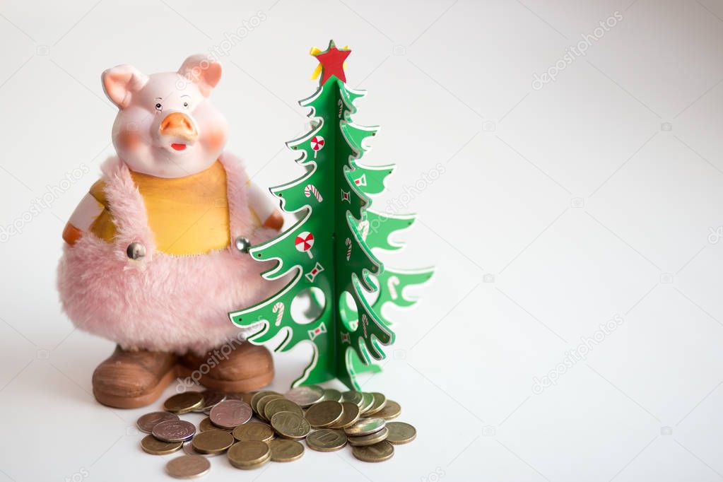 Symbol of the new year. Pig with money under the Christmas tree. Concept: talisman for good luck and wealth