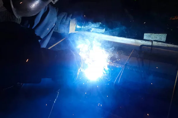 Welding of steel reinforcement. Sparks and light from welding. Electric welding.