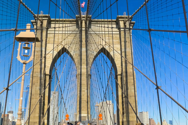 New York, USA - June 20, 2015: The Brooklyn Bridge. Walk on the bridge. Walking through the streets of New York, Manhattan. The life of New York in the afternoon. Streets and city buildings.