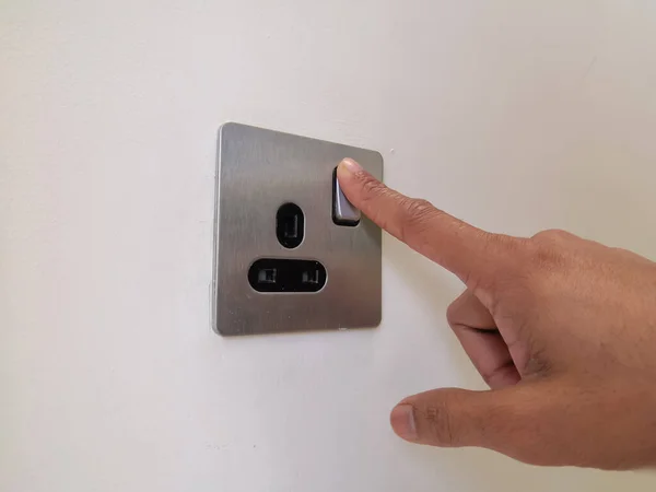 Turning Off Electrical Switch Of Type G Plug With Male Finger