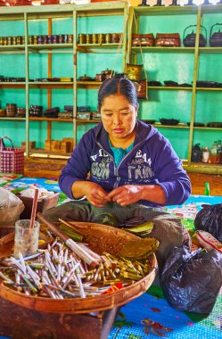 Ywama, Myanmar - 18 Şubat 2018: Birmanya kadın sigara fabrikası Inle Gölü eserlerinde, o puro alır ve sigara içinde muz yaprakları, üzerinde 18 Şubat Ywama içinde.