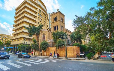 CAIRO, EGYPT - DECEMBER 24, 2017:  The old Church of St Mary of Peace neighbors with tall modern building in Qasr Al Nil street, on December 24 in Cairo clipart