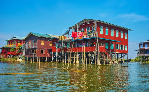 The row of stilt red houses of Inpawkhon vilage on Inle Lake, Myanmar.