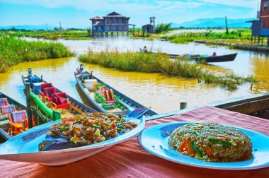 The lake fish with sauce and spicy vegetables and Burmese rice in restaurant on Inle Lake, Ywama, Myanmar.