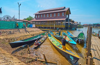 Ywama, Myanmar - 18 Şubat 2018: Küçük iskele yanındaki Hpaung Daw U Pagoda karmaşık Inle Gölü, üzerinde 18 Şubat Ywama içinde binaların içinde renkli kayaklar.