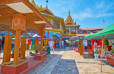 YWAMA, MYANMAR - FEBRUARY 18, 2018: Walk along the market alley in courtyard of Hpaung Daw U Pagoda, on February 18 in Ywama.