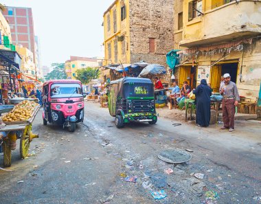Alexandria, Mısır - 18 Aralık 2017: Karmouz bölgesinde, 18 Aralık Alexandria gecekondu Pazar Caddesi boyunca tuk tuks sürücü.