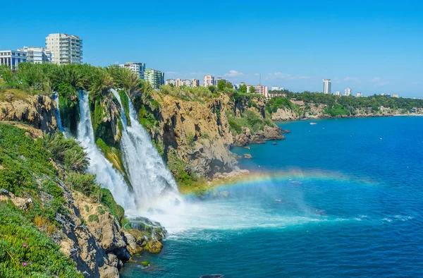 The noisy splashing waters of Lower Duden Waterfall meets the sea, falling from the high rocky cliffs, Antalya, Turkey.