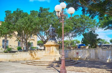 Neobaroque monument to Pietro Floriani in shade of park on Robert Samut Square, Floriana, Malta. clipart